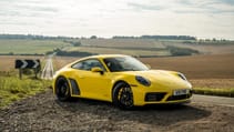 Porsche 911 Carrera 4 GTS coupe yellow front three quarter