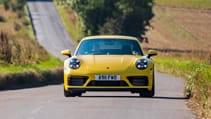 Porsche 911 Carrera 4 GTS coupe yellow on road