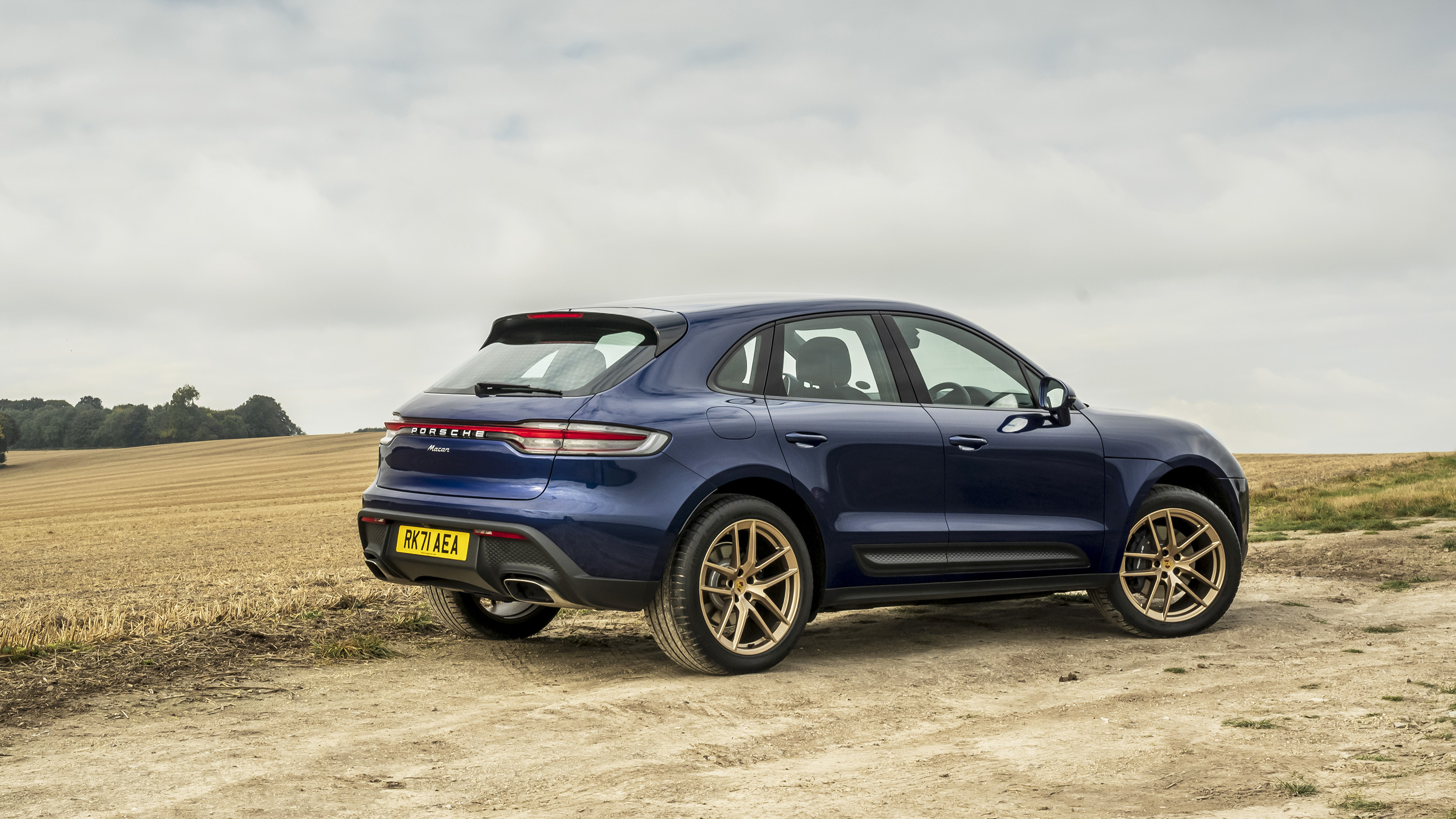 Porsche Macan Gentian Blue on gold wheels