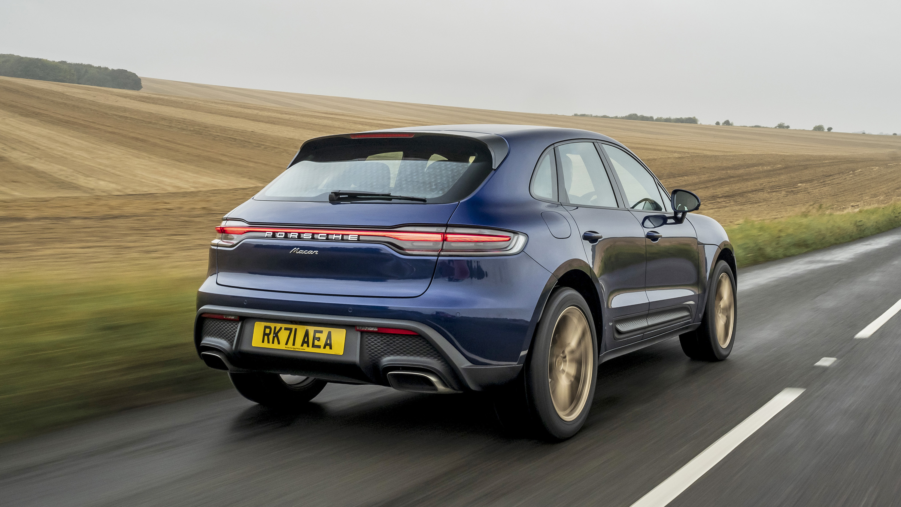 Porsche Macan Gentian Blue on gold wheels rear