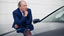 Hans Zimmer leaning on a BMW iX