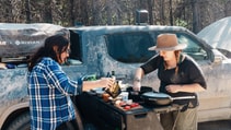 Rivian R1T with two women having a barbecue 