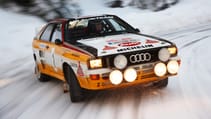 Audi rally car performs ice slide on snow slicked track