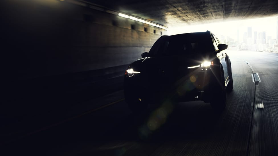 Teaser shot of new Mazda CX-90 in tunnel with light behind