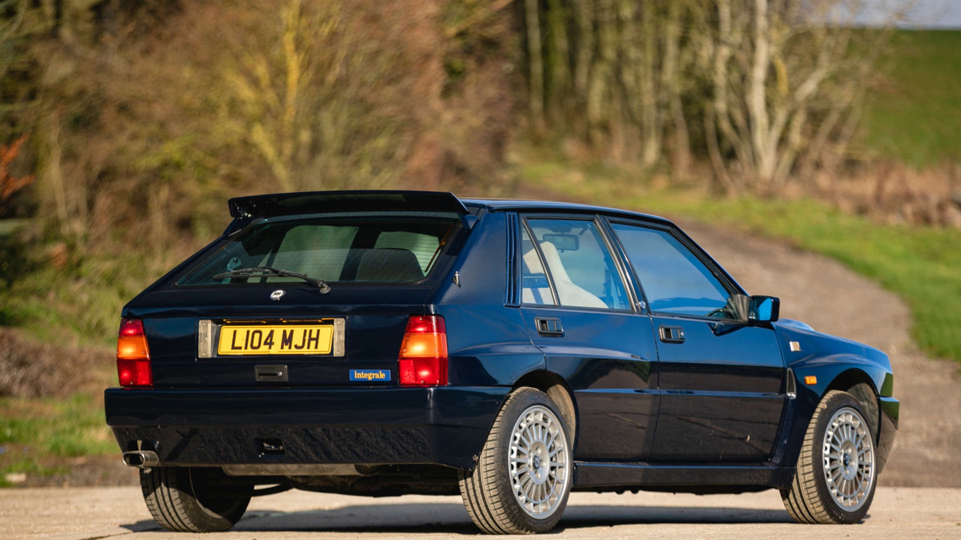 Rowan Atkinson-owned Lancia Delta Integrale Eco II full shot in sun of car from rear