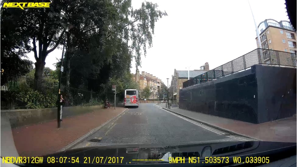 A static shot of a recorded frame from a Nextbase dash cam on a residential street