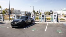 The new Porsche Macan sits on charge in a car park