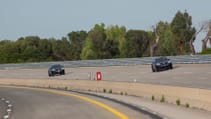 Two Porsche Macans being tested on a speed track
