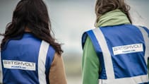 Two site visitors with their backs to the camera, wearing Britishvolt logo on visibility vests