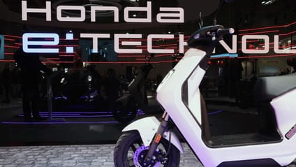 Honda EM1 e: scooter on the stage at launch with Honda E-Technology branding in background