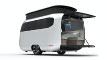 Studio shot of Airstream Studio Porsche travel trailer concept with pop top popped and rear doors dropped