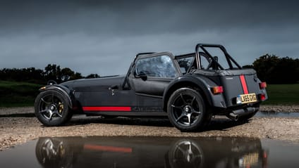 Rear shot of Caterham Seven two-seater reflecting in a puddle