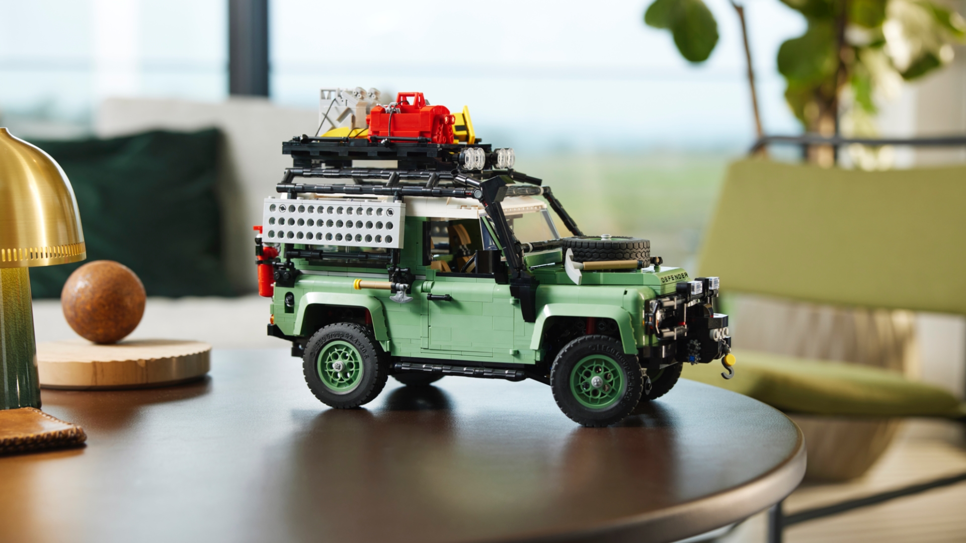 Lego classic Land Rover Defender 90 sits on a desk, surrounded by other knick-knacks