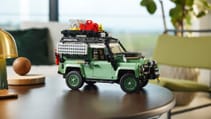 Lego classic Land Rover Defender 90 sits on a desk, surrounded by other knick-knacks