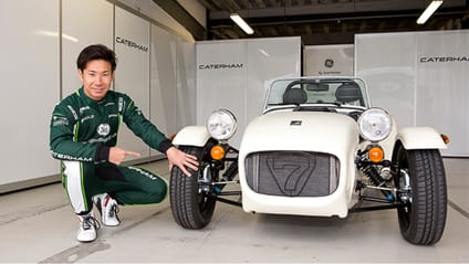 Kamum Kobayashi kneeling next to a special edition Caterham Seven