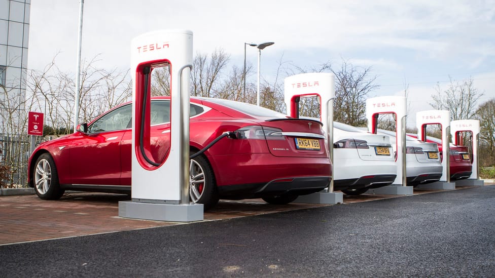 Line of Tesla Superchargers with Tesla Model S parked in sequence