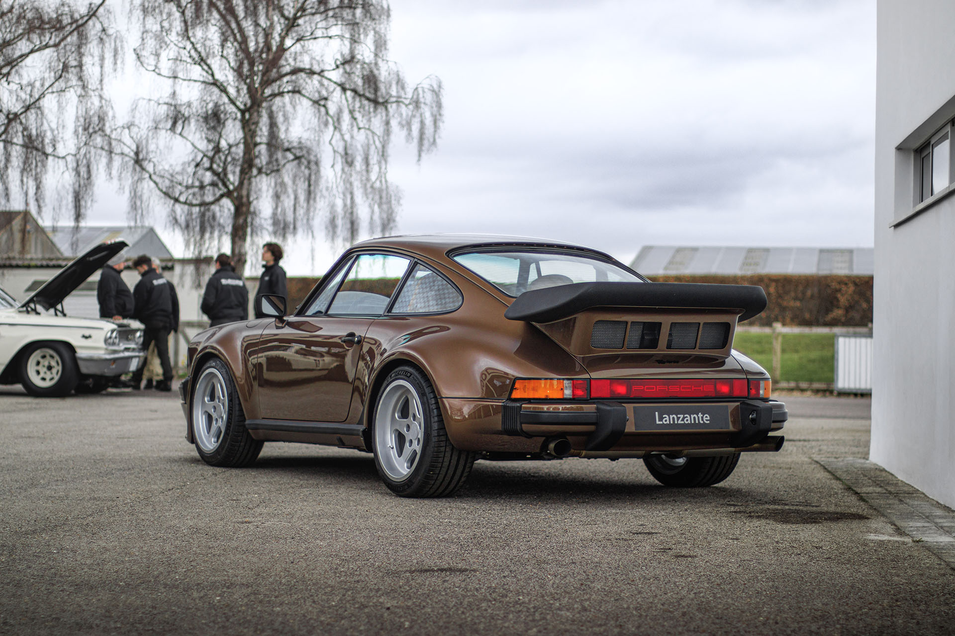 Lanzante 930 TAG Turbo sits parked at Goodwood media centre, shot from rear