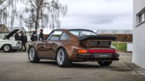 Lanzante 930 TAG Turbo sits parked at Goodwood media centre, shot from rear