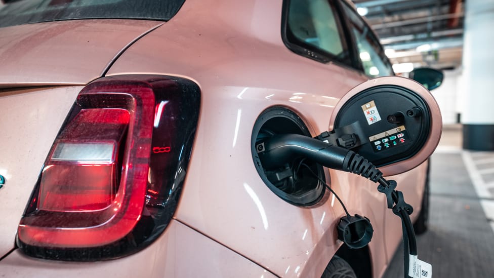 Close up of charging cable plugged into electric car