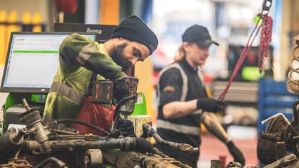 Recycling workers dismantling car parts