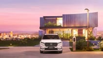 Head on shot of all-new Honda CR-V in front of futuristic property during a purple sunset