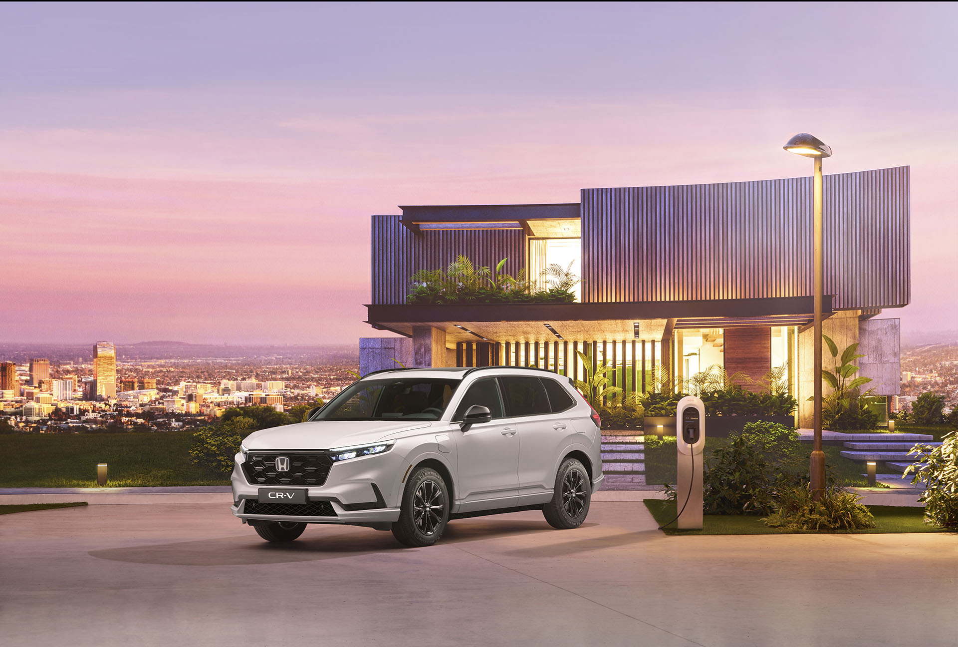 Front shot of all-new Honda CR-V in front of futuristic property during a purple sunset