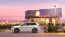 Side profile of all-new Honda CR-V in front of futuristic property during a purple sunset