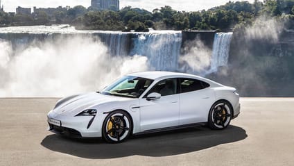 Static shot in front of waterfall of Porsche Taycan