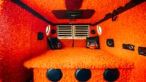 A 1977 Dodge Tradesman interior speaker suite with orange shag carpet