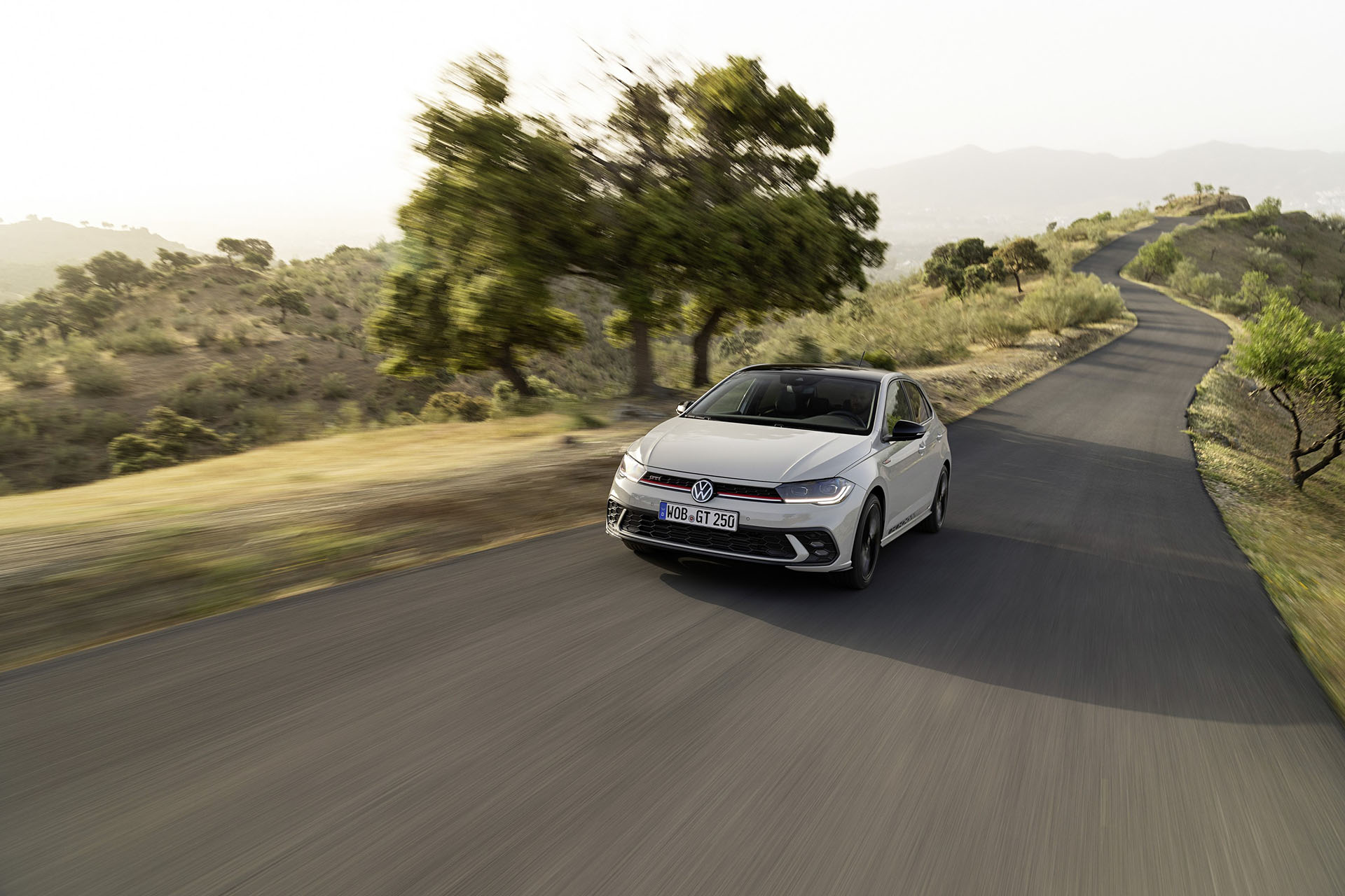 Driving shot of VW Polo GTI Edition 25 with hazy fields backdrop