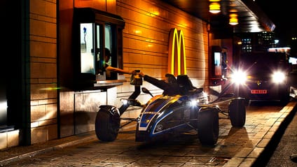 Car and driver at the window of a drive-thru restaurant