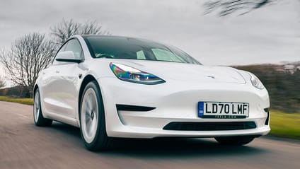 White Tesla Model 3 in driving shot, most searched for electric car