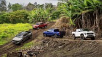 Wide shot of four Toyota Tacoma in different colours on a dirt track