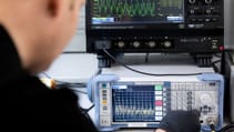 Lab shot of engineer monitoring charging and discharge cycles on batteries