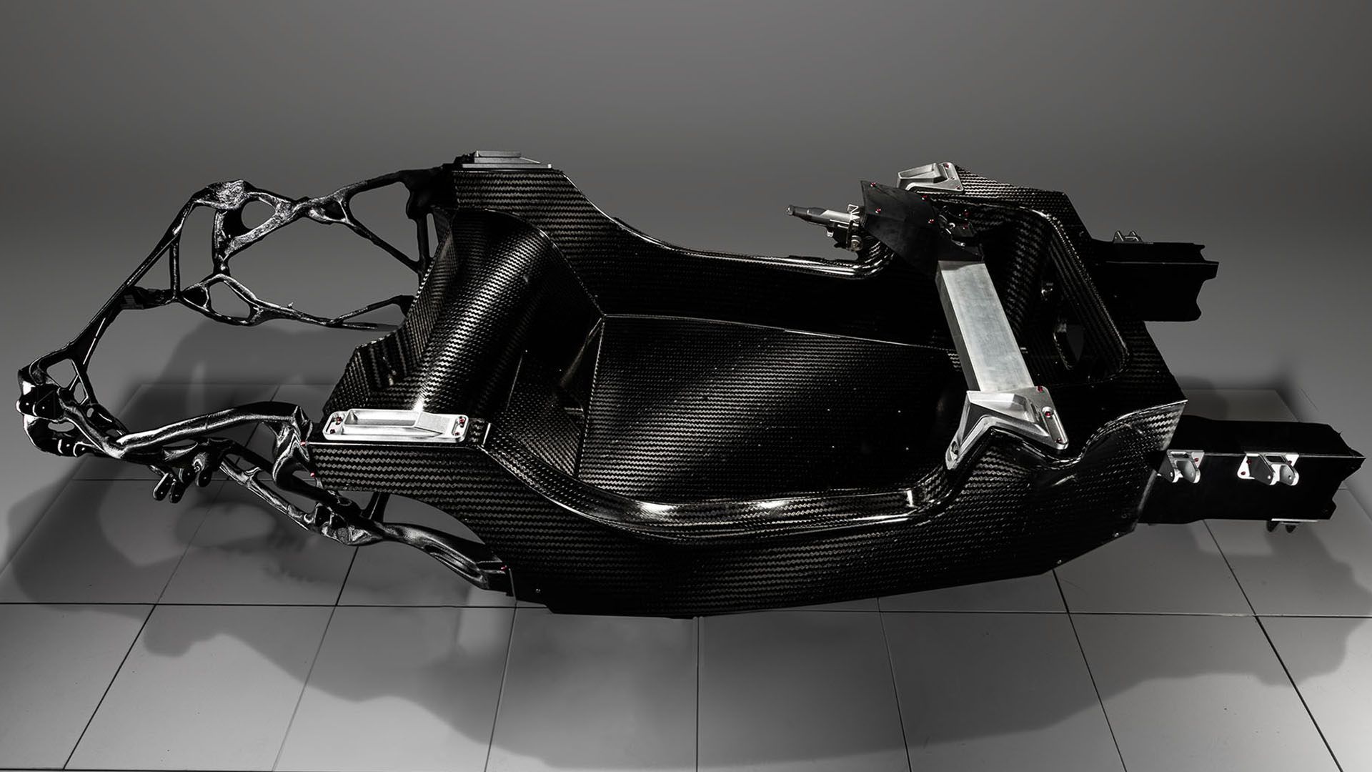 Dash-cae carbon-fibre chassis in static studio shot - high angle shot of whole unit