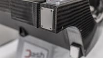 Dash-cae carbon-fibre chassis in static studio shot - close up