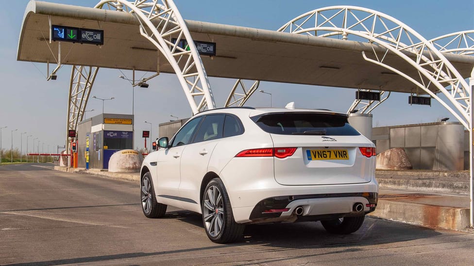 Jaguar I-Pace on a toll road under the booth to show payment required