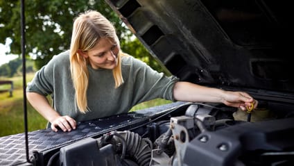 Someone inspecting the engine of their car