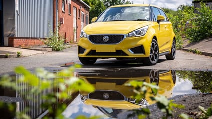 Static shot of yellow MG3 with reflection in puddle in foreground