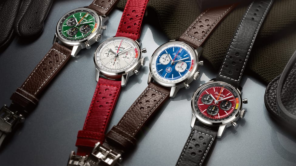 Four Breitling Top Time Classic Cars collection watches sitting together with coloured watch straps