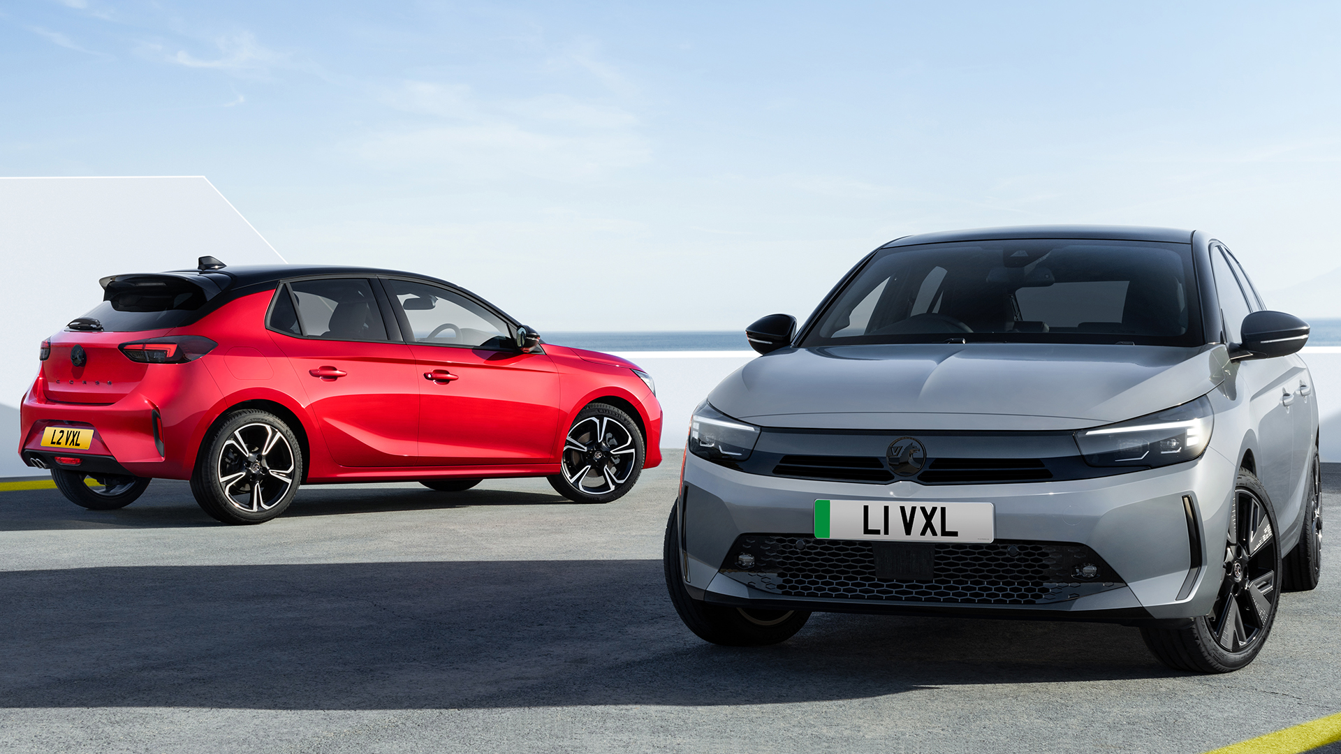 Two Vauxhall Corsa sit in the frame in a static shot