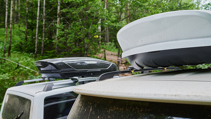 Two roof boxes on cars