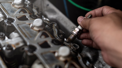 A motoring mechanic connecting a part