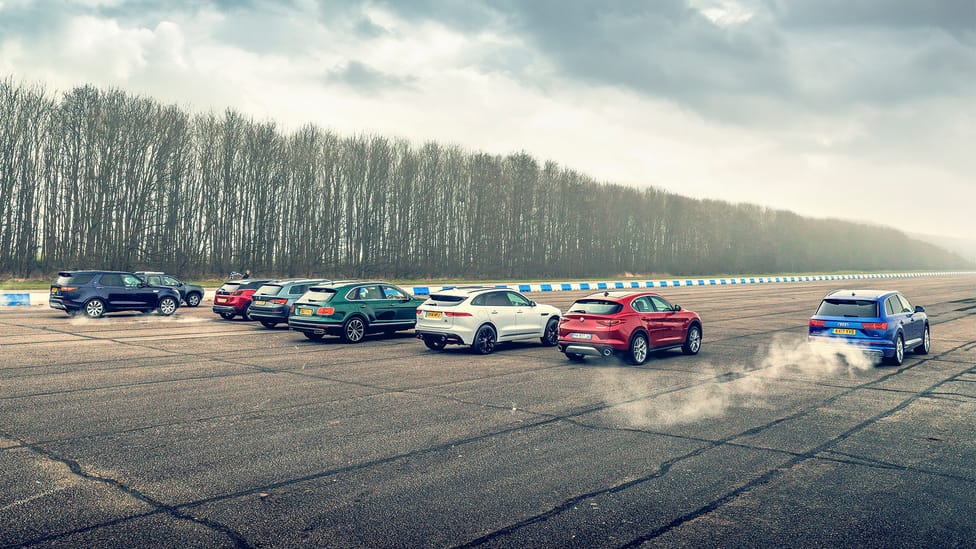 Group of various SUVs shot from the rear, preparing to race each other off the start line