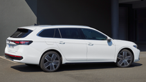 The new 2024 VW Passat Variant in white in a static side shot with a blue sky background