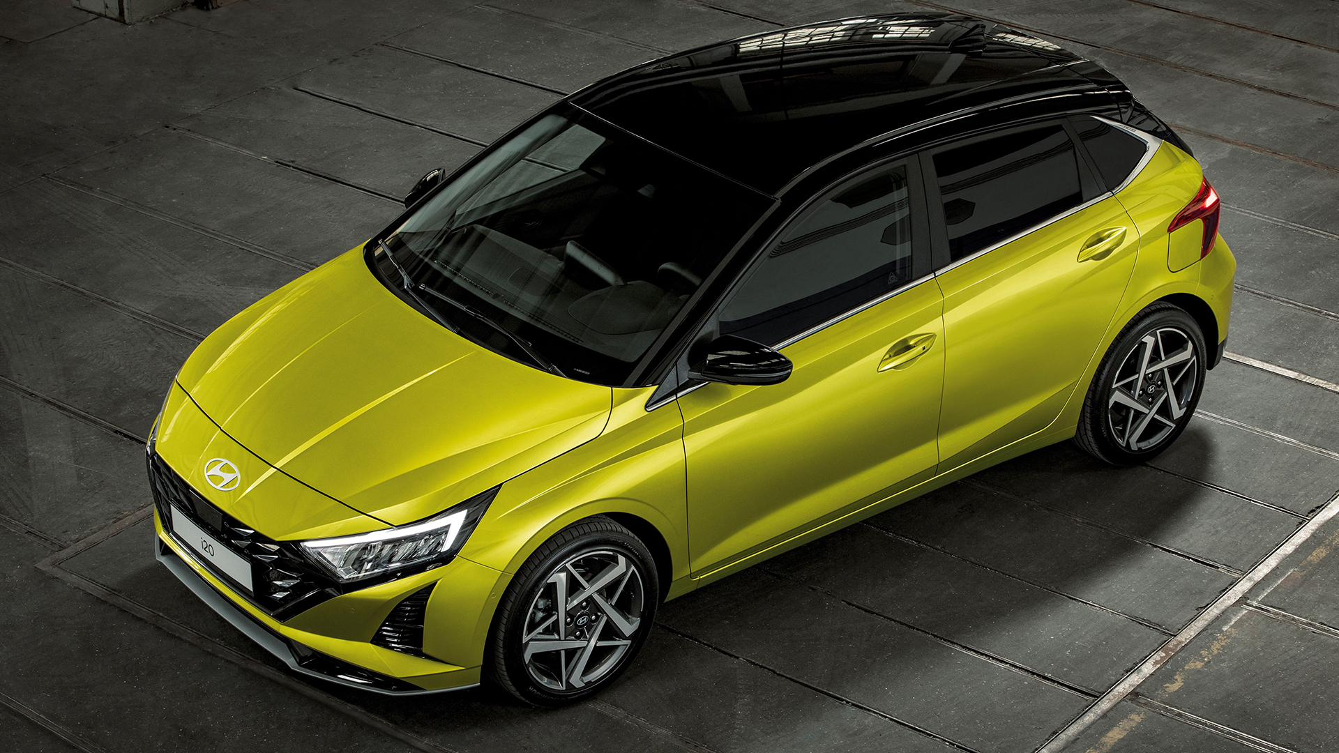 High angle of profile of new Hyundai i20 in hot lime colour