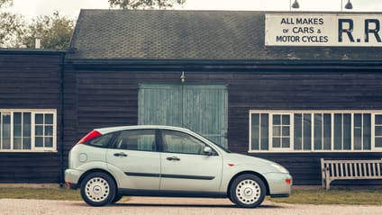 1998 Ford Focus in side profile shot with old-school garage backdrop