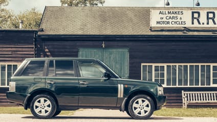 Range Rover 2002 in side profile shot with old-school garage backdrop