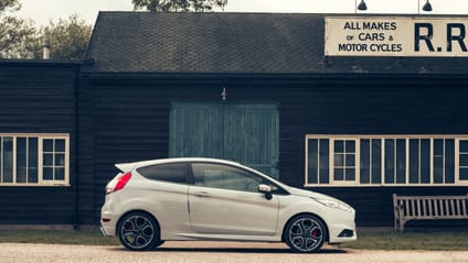 2013 Fiesta in side profile shot with old-school garage backdrop