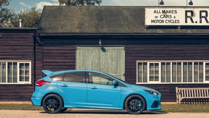 2015 Focus RS in side profile shot with old-school garage backdrop